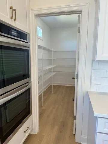 a kitchen with an oven and cabinets