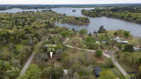 an aerial view of house with yard lake and mountain view