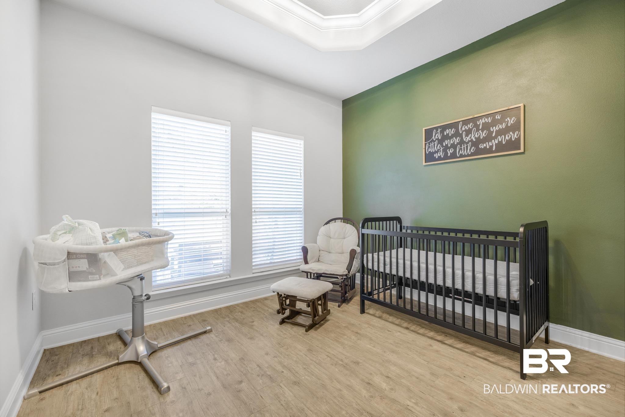31336 Hoot Owl Road Daphne, AL 36527 - Photo 20 of 36 Bedroom featuring a nursery area, light wood-style flooring, a raised ceiling, and crown molding