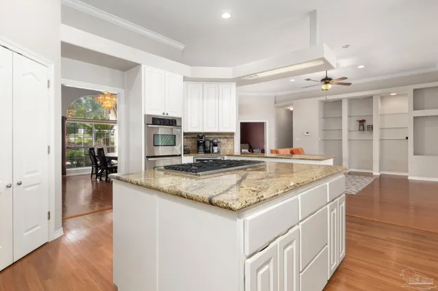 a view of a dining room with furniture wooden floor and chandelier