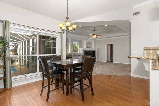 a view of an empty room with window hardwood floor and a ceiling fan