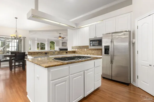 a living room with furniture and large windows