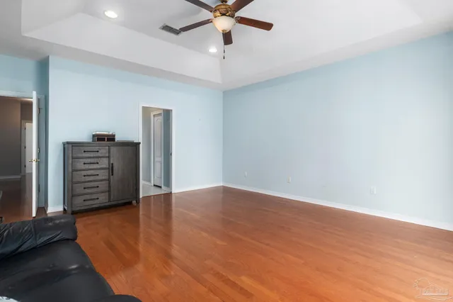 a view of an empty room with a fireplace and a window