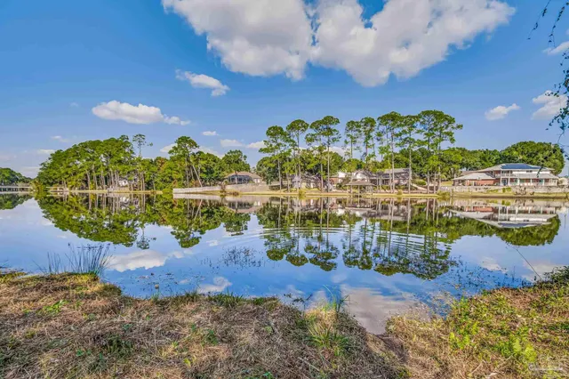 a kitchen with kitchen island granite countertop a sink cabinets and wooden floor