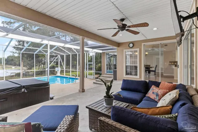 a view of a swimming pool with a glass door and chair