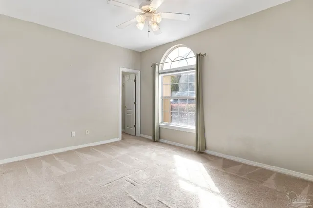 a view of a swimming pool with a glass door and chair