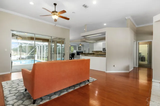 an empty room with fireplace chandelier fan and windows