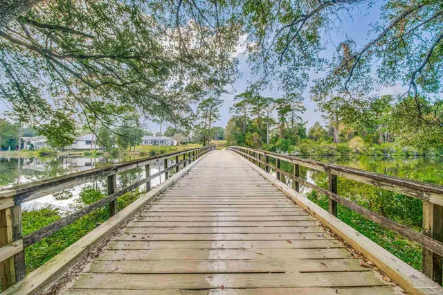a view of a lake with a table and chairs in patio