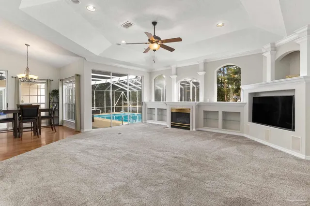 a kitchen with stainless steel appliances a stove top oven a refrigerator a sink and dishwasher with wooden floor