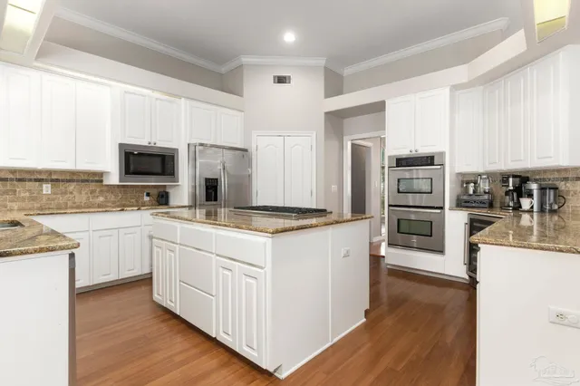 a view of an empty room with window hardwood floor and a ceiling fan