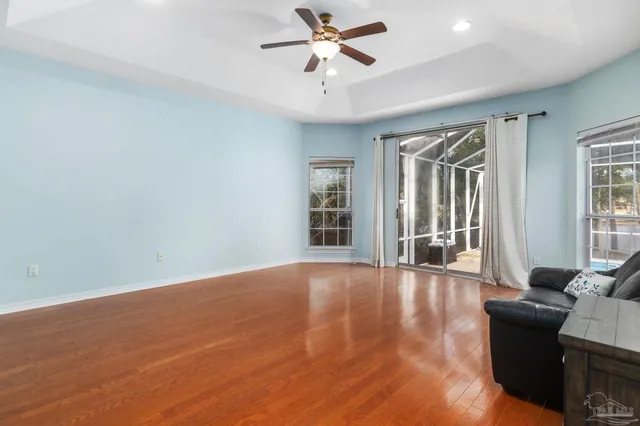 a spacious bathroom with a tub sink and mirror