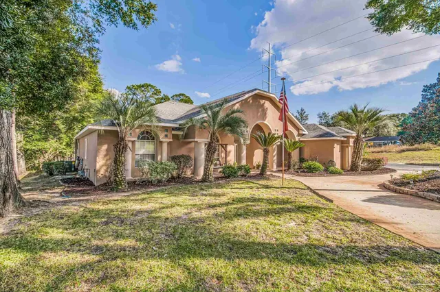 a view of a house with backyard and balcony