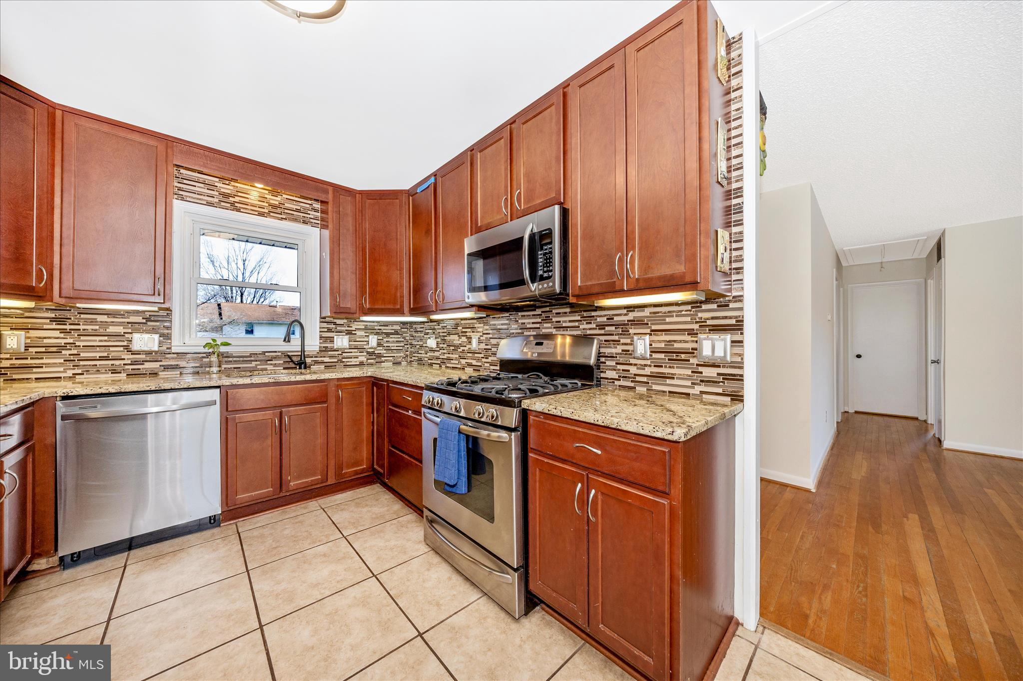 1606 Wise Road Point of Rocks, MD 21777 - Photo 14 of 67 a kitchen with stainless steel appliances granite countertop wooden cabinets a stove top oven a sink and dishwasher