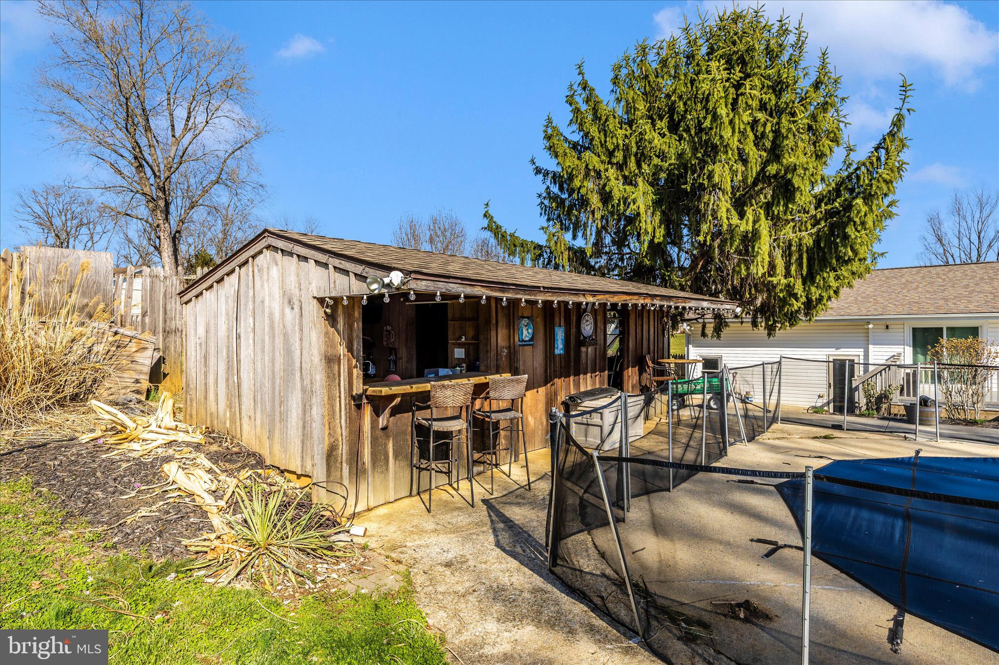 1606 Wise Road Point of Rocks, MD 21777 - Photo 63 of 67 a view of a patio with table and chairs under an umbrella with wooden fence