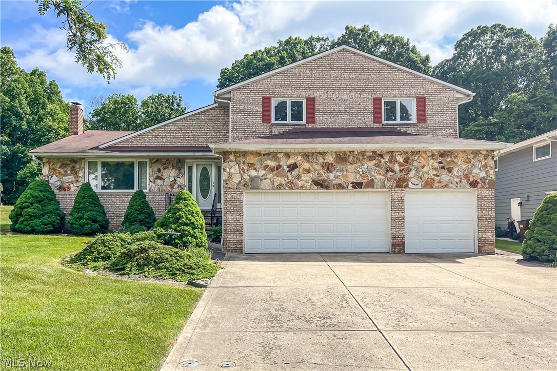 Front facade featuring a front yard and a garage