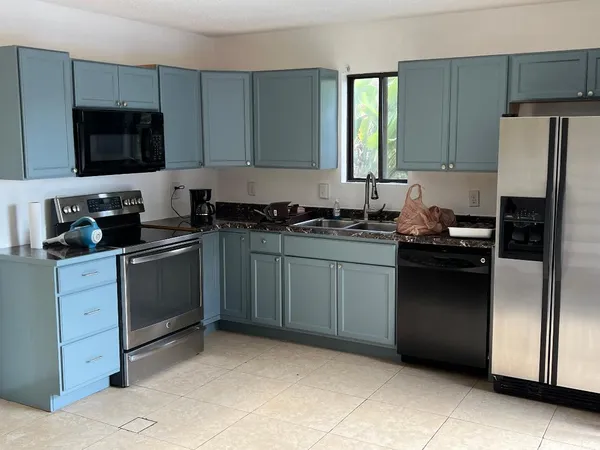 a kitchen with a sink stove and refrigerator