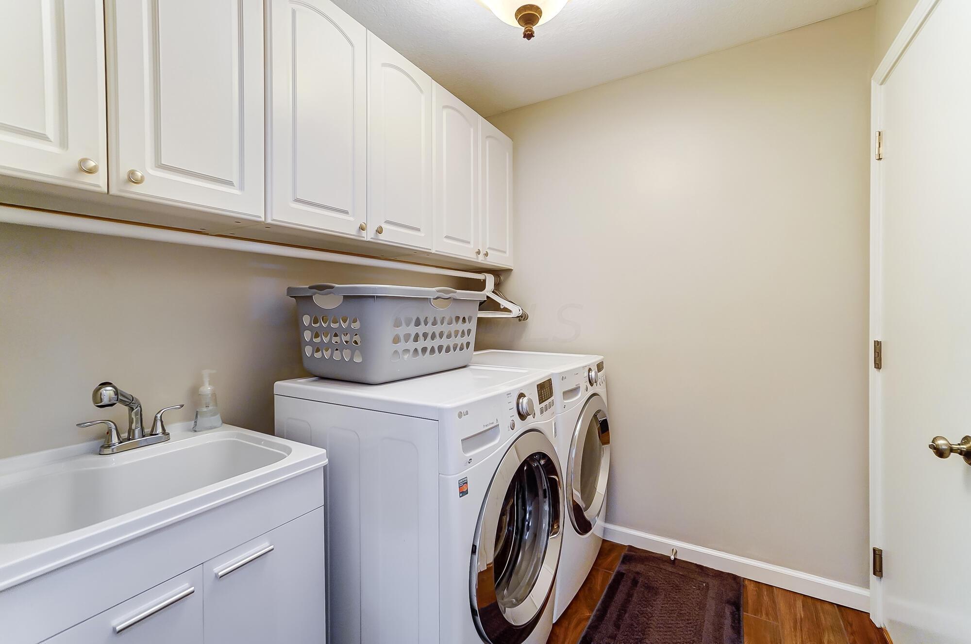 5674 Steward Road Galena, OH 43021 - Photo 71 of 82 Laundry center boast ample room to get the clothes clean, new utility sink and cabinetry for all your laundry cleaning supplies