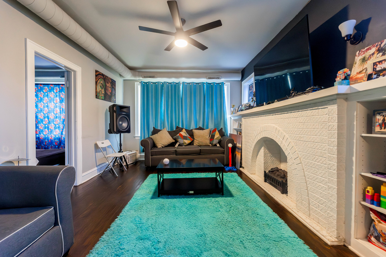 12258 South Normal Avenue Chicago, IL 60628 - Photo 11 of 21 a living room with furniture a flat screen tv and a fireplace