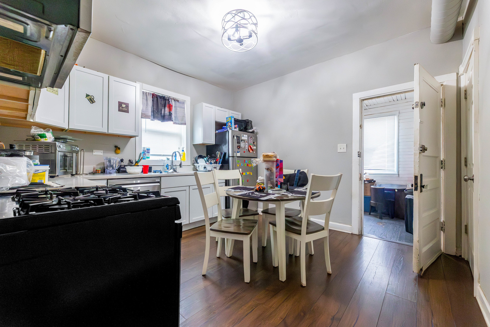 12258 South Normal Avenue Chicago, IL 60628 - Photo 16 of 21 a kitchen with stainless steel appliances a dining table and chairs