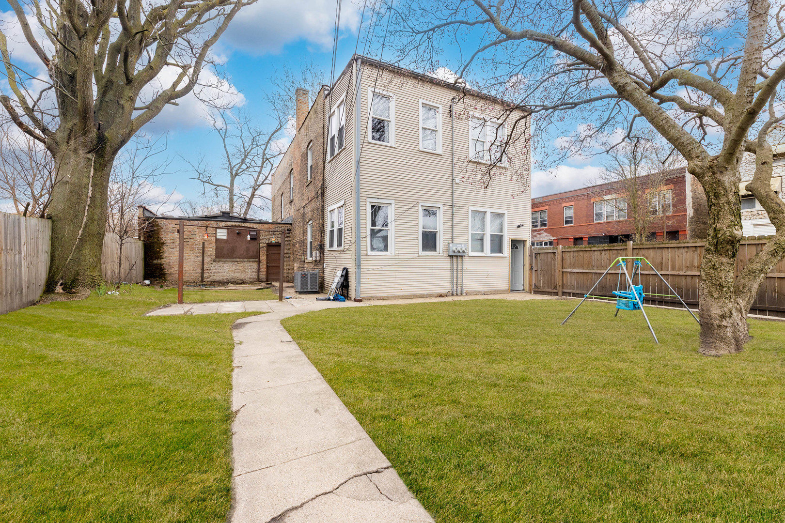 12258 South Normal Avenue Chicago, IL 60628 - Photo 21 of 21 a swimming pool with yard and trees in the background