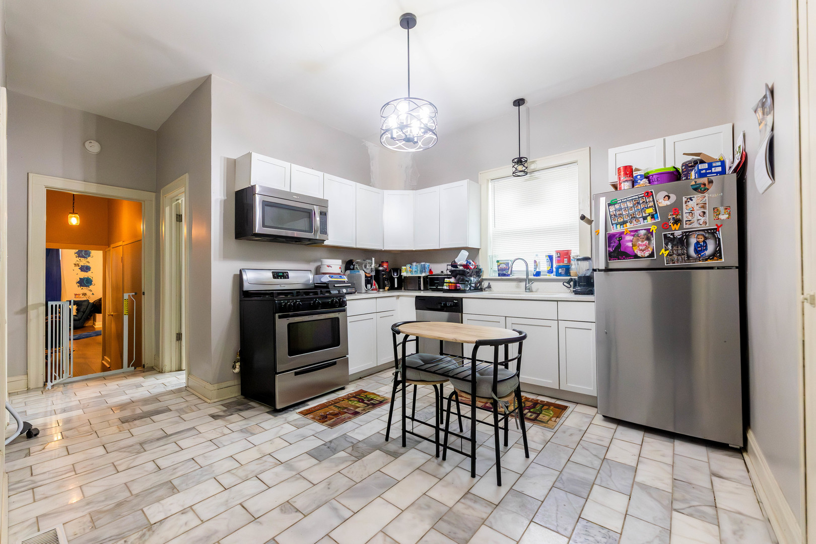 12258 South Normal Avenue Chicago, IL 60628 - Photo 6 of 21 a kitchen with stainless steel appliances granite countertop a refrigerator and a stove top oven