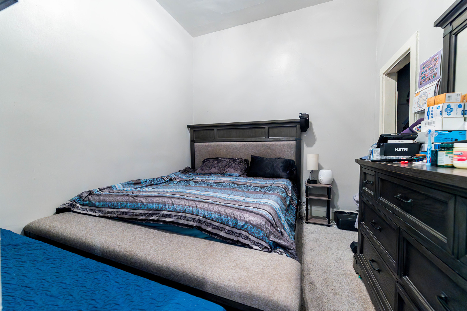 12258 South Normal Avenue Chicago, IL 60628 - Photo 7 of 21 a bedroom with a bed and a flat tv screen on a dresser