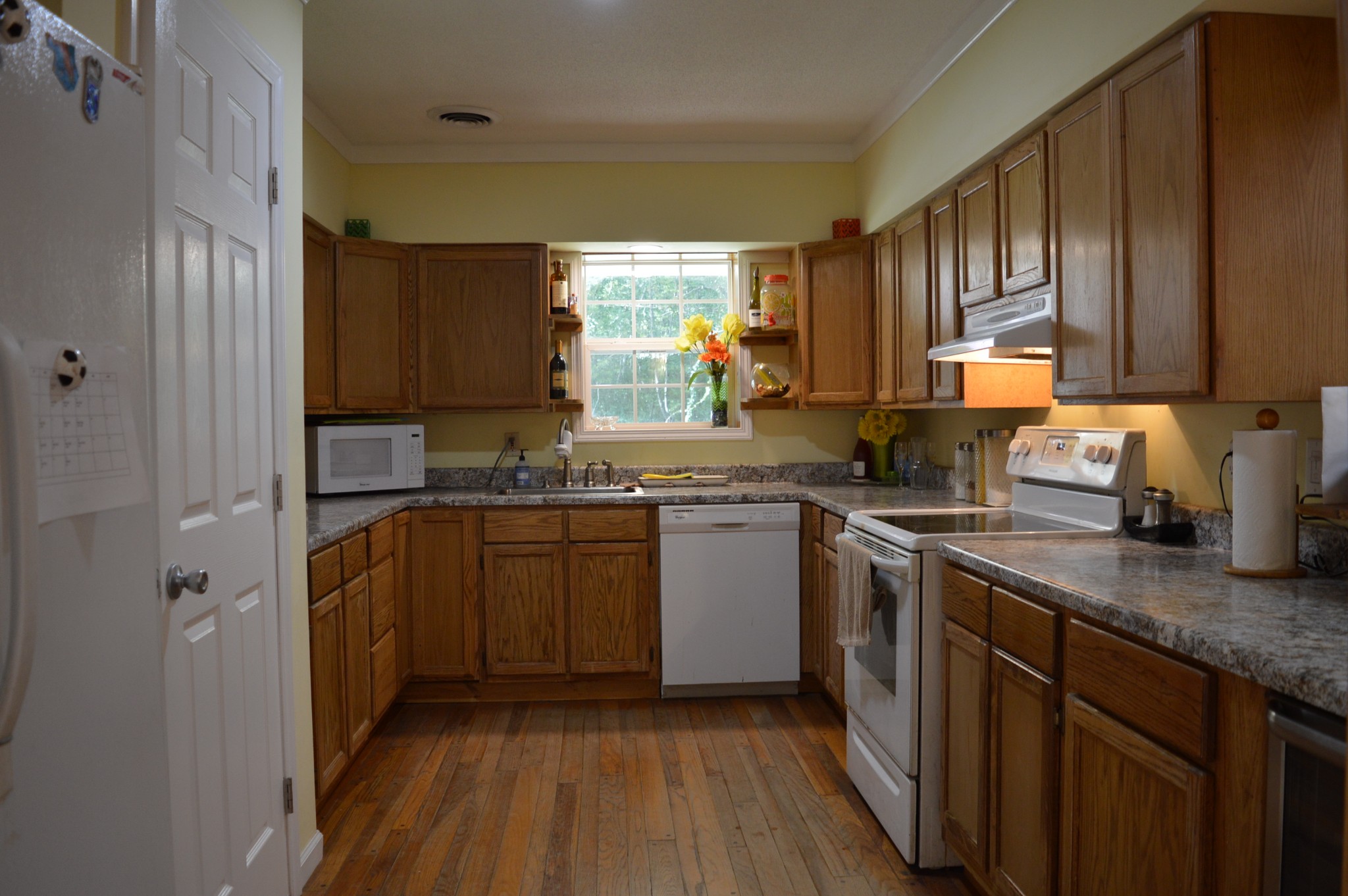 197 Midway Road Sewanee, TN 37375 - Photo 10 of 15 a kitchen with stainless steel appliances granite countertop wooden cabinets granite counter tops and a window