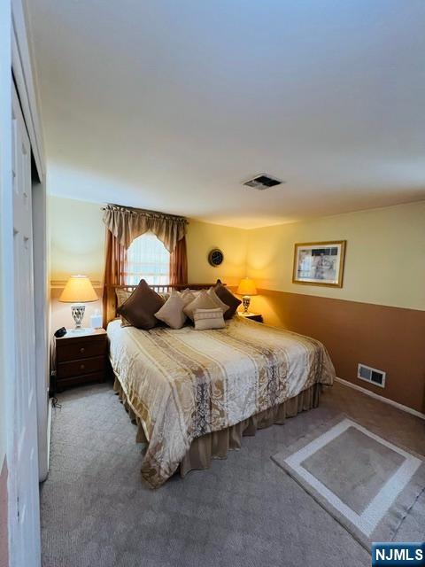 26 Donna Court Nutley, NJ 07110 - Photo 12 of 34 a spacious bedroom with a bed and lamp