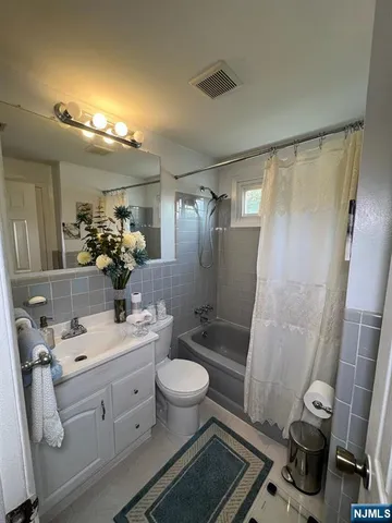 a bathroom with a double vanity sink mirror double and toilet