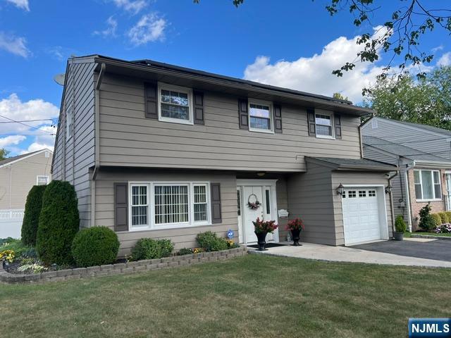 26 Donna Court Nutley, NJ 07110 - Photo 2 of 34 a front view of a house with a garden