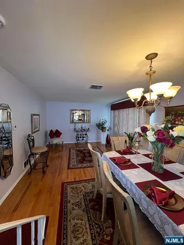 a kitchen that has a lot of cabinets a stove and a wooden floor