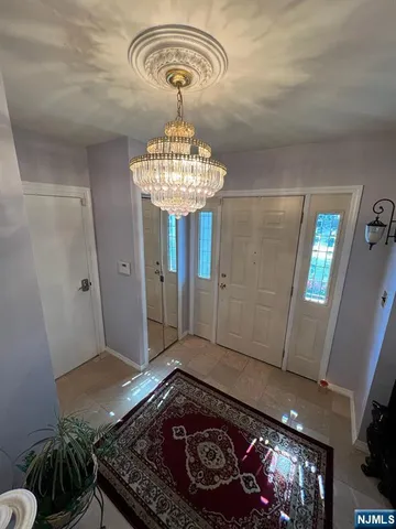 a very nice looking dining room with a table chairs and a chandelier