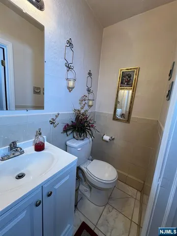 a bathroom with a sink mirror and toilet