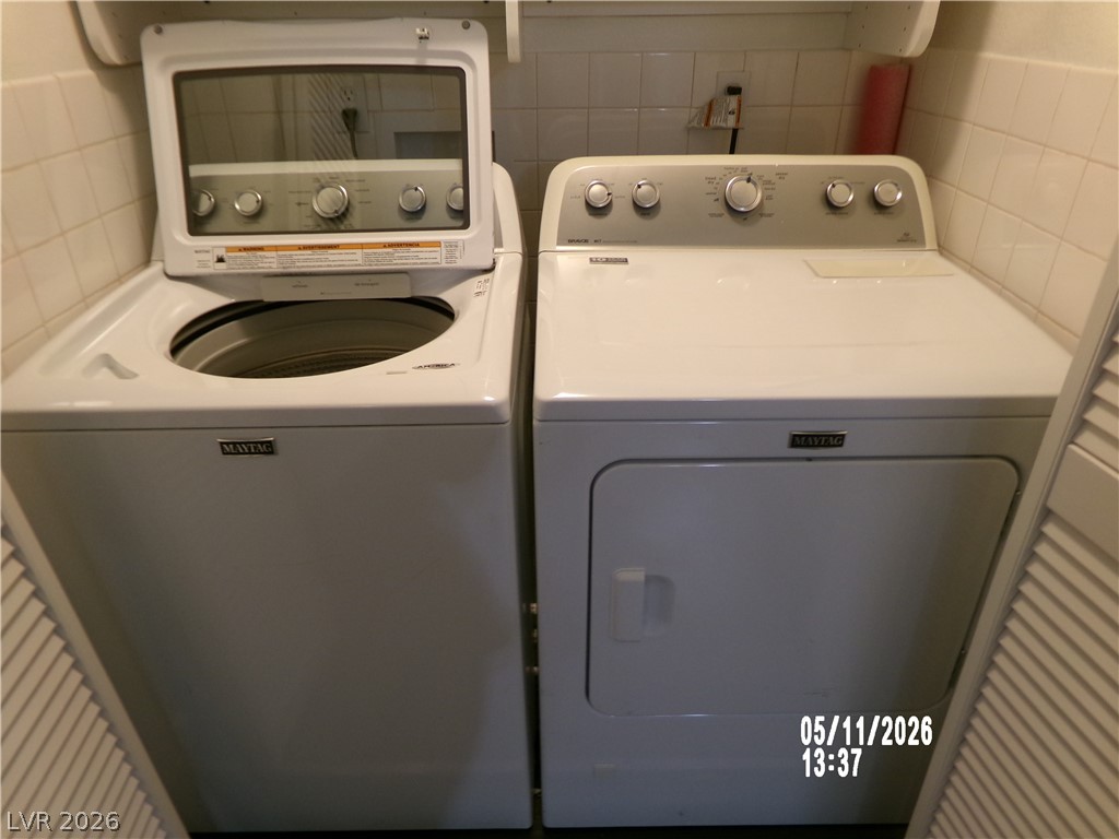 2995 East Sunset Road, Unit 222 Las Vegas, NV 89120 - Photo 16 of 29 This dedicated laundry area offers essential appliances for effortless household tasks.