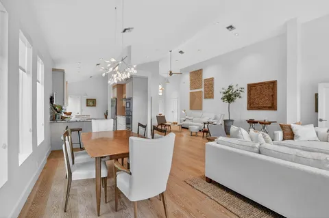 a kitchen with stainless steel appliances kitchen island granite countertop a stove a sink and white cabinets
