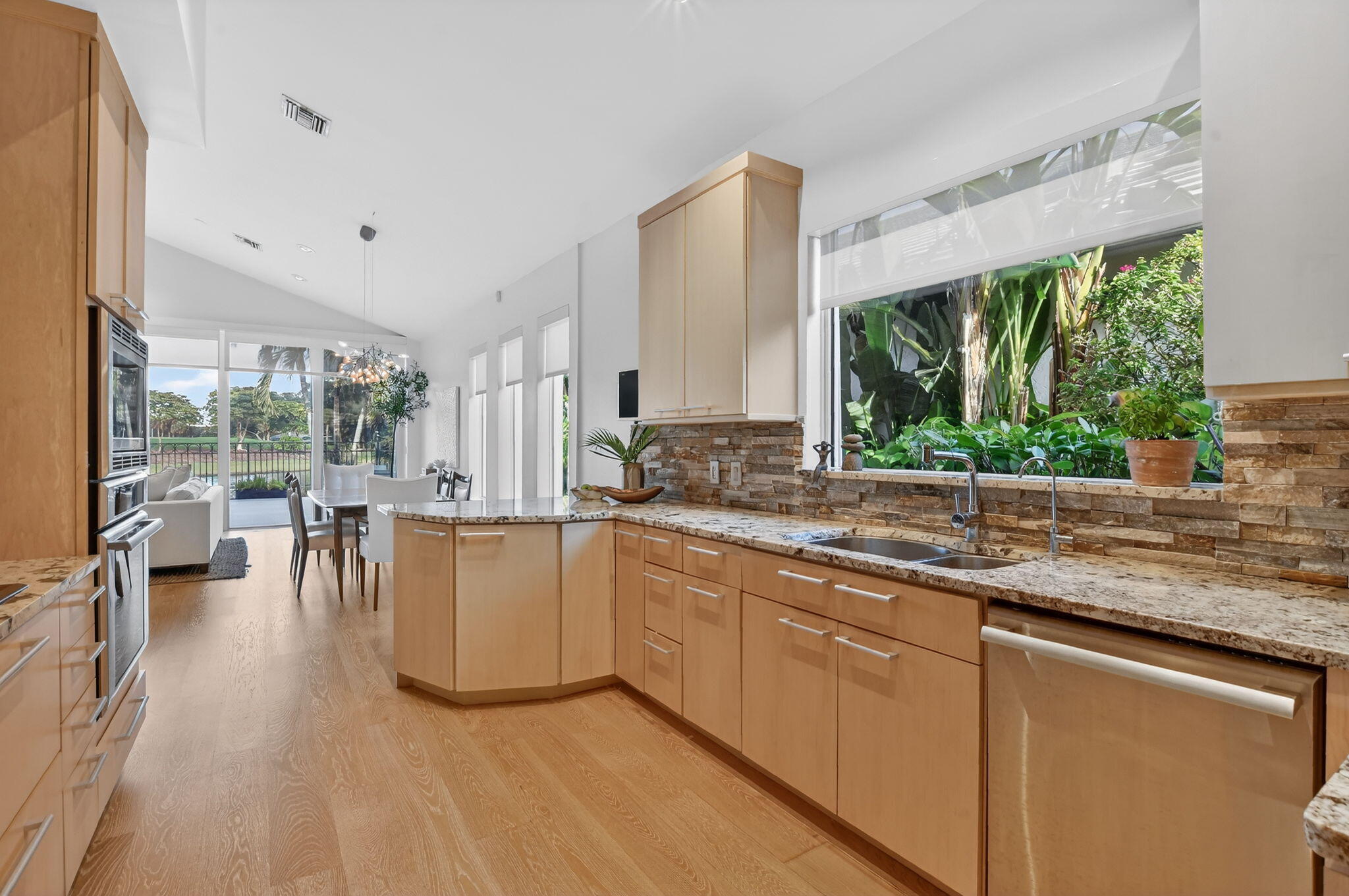 2051 Northwest 56th Street Boca Raton, FL 33496 - Photo 17 of 58 a kitchen with stainless steel appliances granite countertop a stove a sink and a refrigerator
