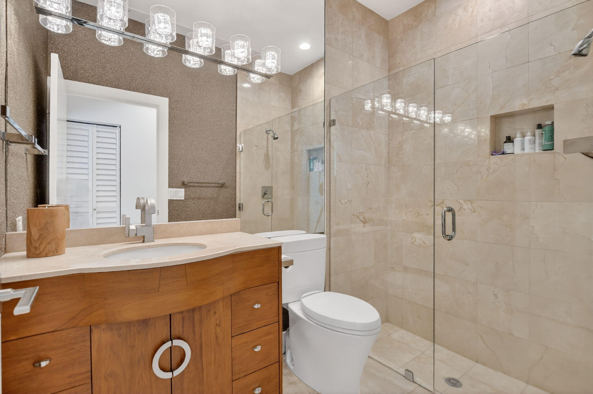 2051 Northwest 56th Street Boca Raton, FL 33496 - Photo 32 of 58 a bathroom with a sink a toilet a mirror and shower