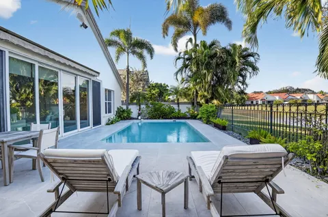 a view of a patio with a table and chairs and potted plants