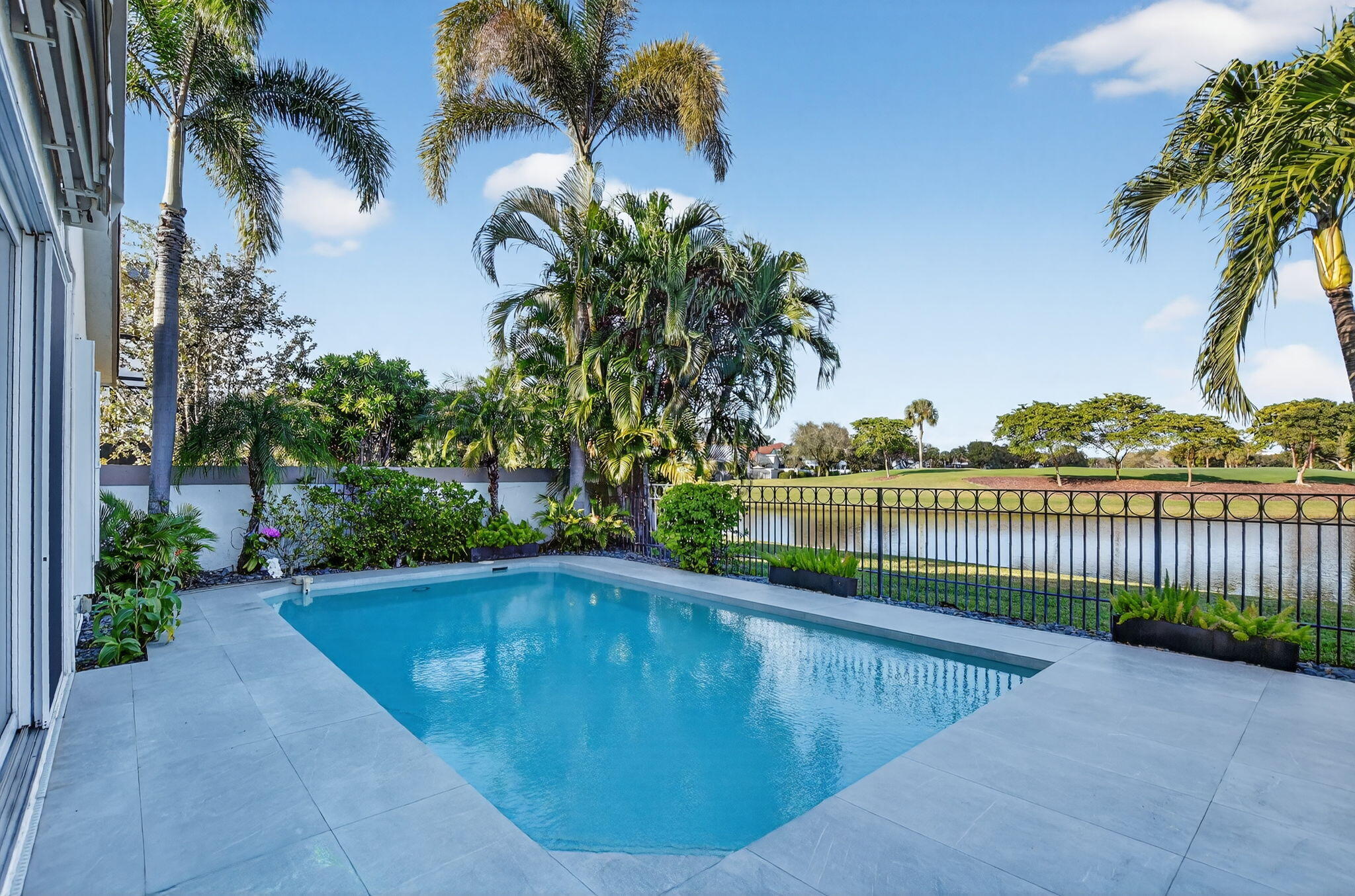 2051 Northwest 56th Street Boca Raton, FL 33496 - Photo 38 of 58 a view of a swimming pool with a patio