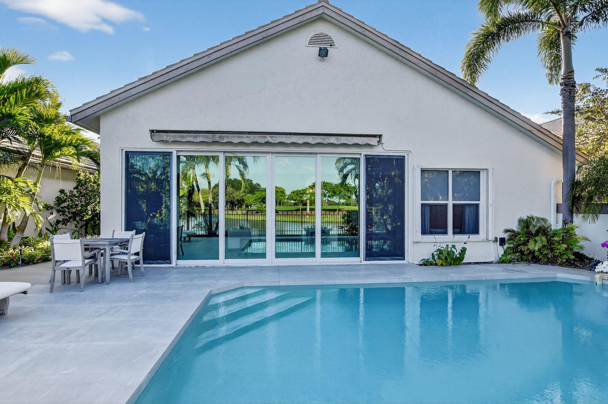 2051 Northwest 56th Street Boca Raton, FL 33496 - Photo 41 of 58 a front view of a house with garden