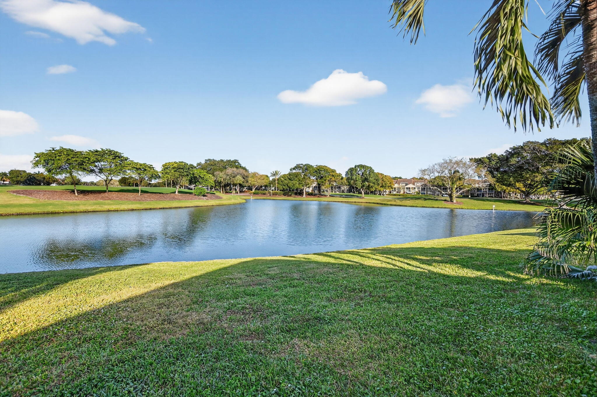 2051 Northwest 56th Street Boca Raton, FL 33496 - Photo 44 of 58 a view of a lake with houses in the back