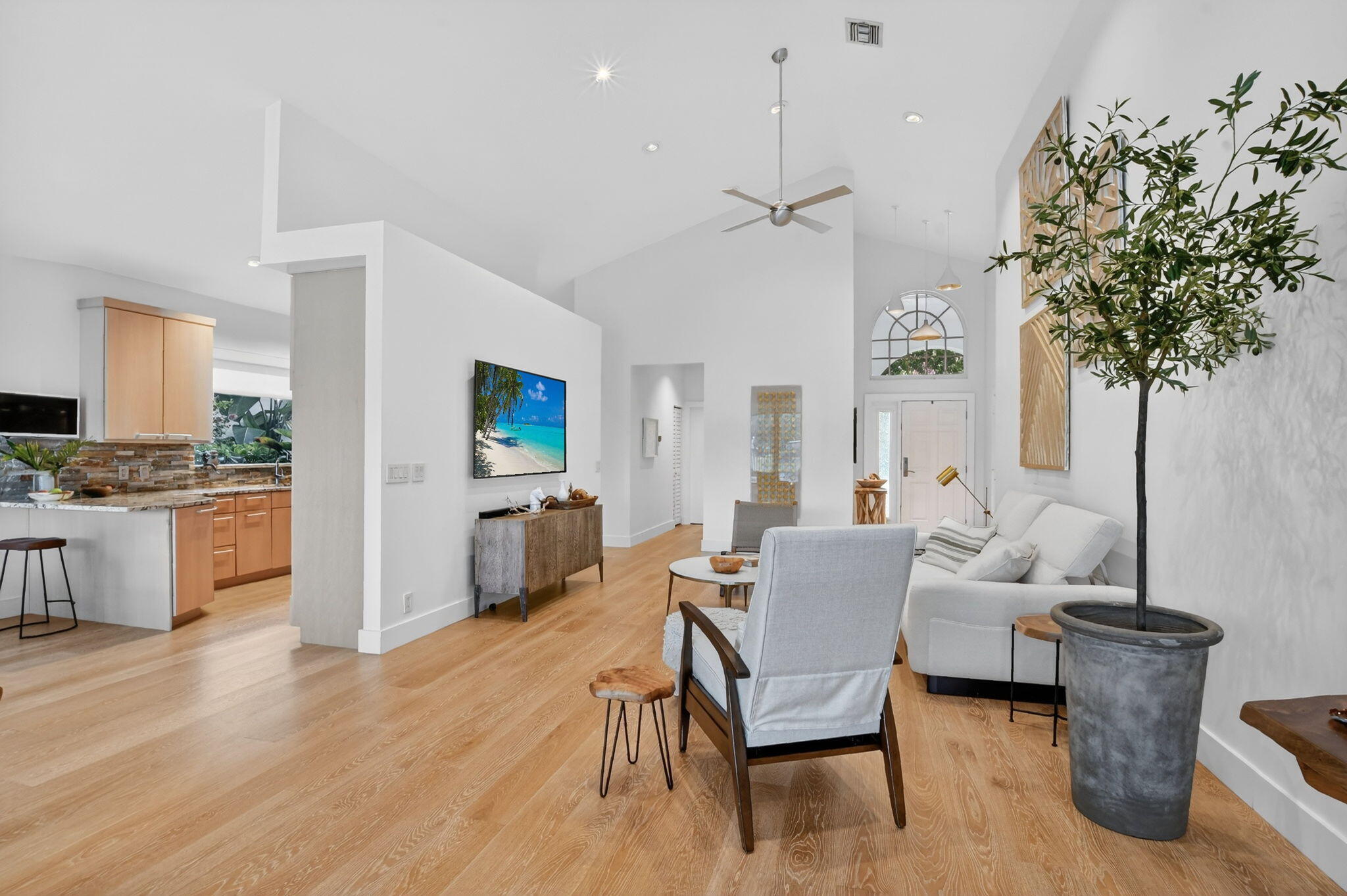 2051 Northwest 56th Street Boca Raton, FL 33496 - Photo 6 of 58 a living room with furniture and a kitchen
