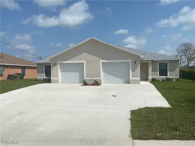 a front view of house with yard and trees