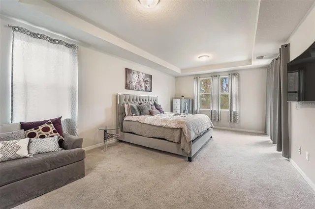 a bedroom with a bed couch and a window