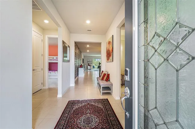 a hallway with a dining table and chairs