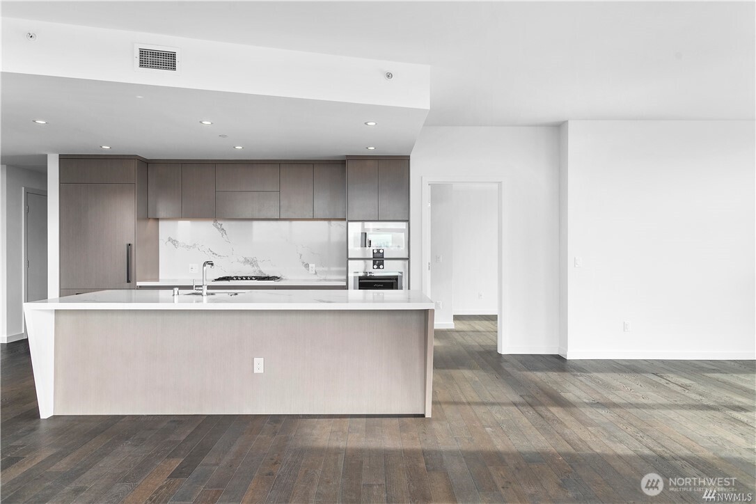 188 Bellevue Way Northeast, Unit 1907 Bellevue, WA 98004 - Photo 15 of 36 a view of kitchen with stainless steel appliances cabinets and wooden floor