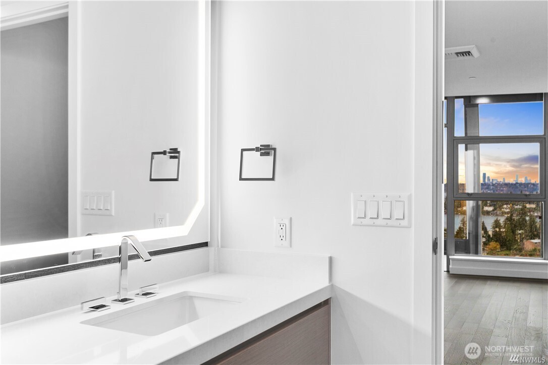 188 Bellevue Way Northeast, Unit 1907 Bellevue, WA 98004 - Photo 19 of 36 a bathroom with a sink and a mirror