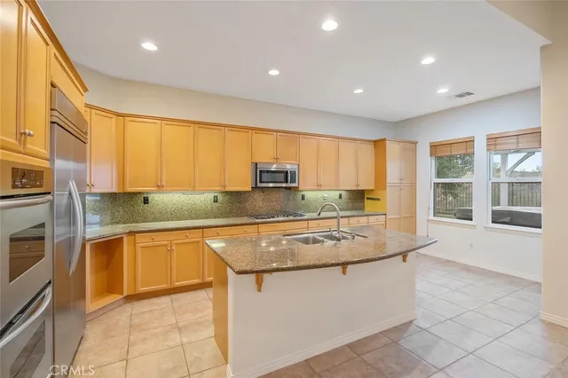 a kitchen with stainless steel appliances granite countertop a sink and cabinets