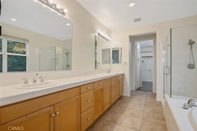 a spacious bathroom with a double vanity sink mirror and double