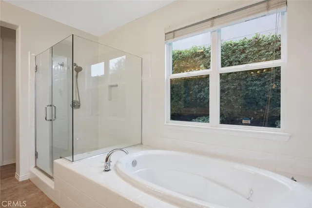a white bath tub sitting next to a shower